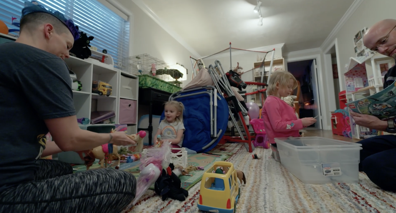 Rai Doty playing with toys with her two daughters.